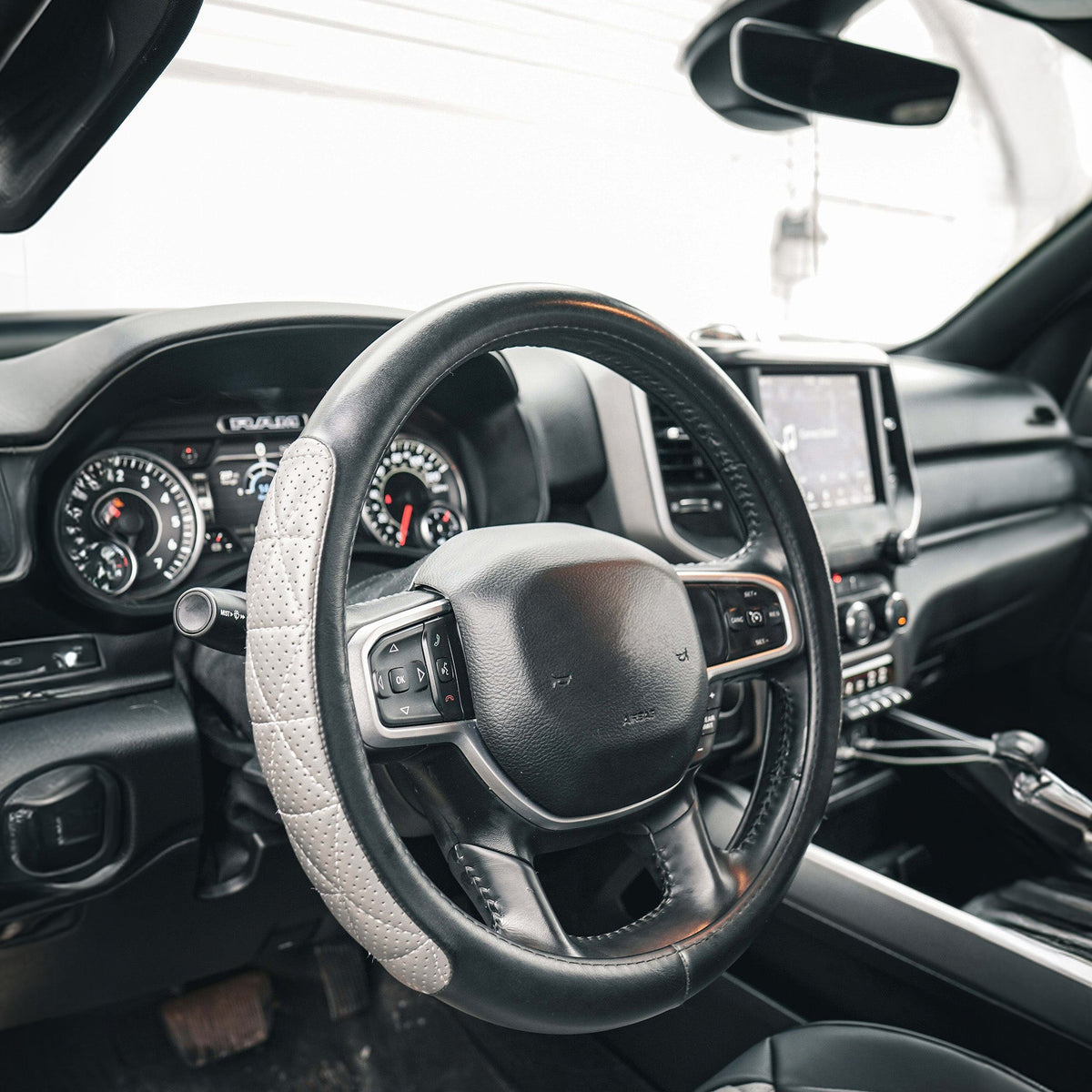 Steering wheel cover fitted inside a car, detail view